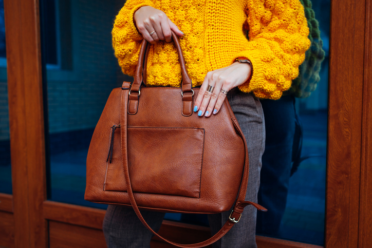 Woman holding handbag.